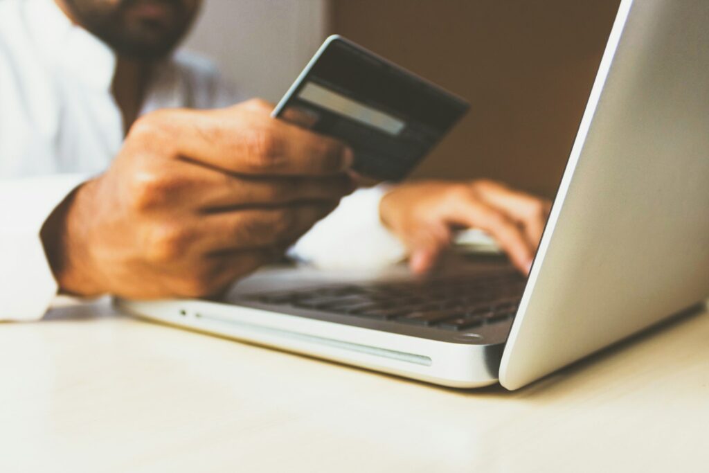 Person entering payment card details on a laptop to complete an online purchase, representing AppSumo lifetime deal checkout